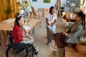 Accessible art therapy session with diverse women in creative studio community.